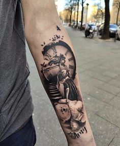 a man with a clock tattoo on his arm