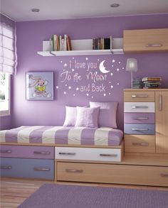 a bedroom with purple walls and drawers in the corner, there is a wall decal that says i love you to the moon and back