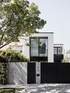 an entrance to a house with black and white architecture