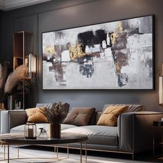 a living room filled with furniture and a large painting on the wall above it's coffee table