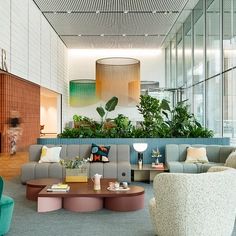 a living room filled with lots of furniture next to a fire place and planter