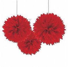 three red pom - poms hanging from strings in the shape of flowers on a white background