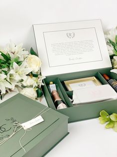 an open gift box with flowers and other items