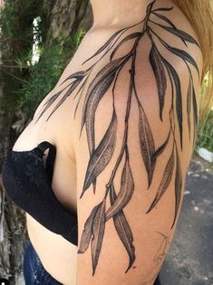 a woman's shoulder with leaves on it, and the back of her breast