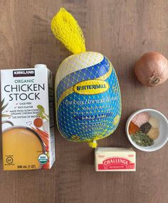 ingredients to make chicken stock laid out on a wooden table next to an egg and carton of butter