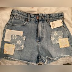 Billabong X Wrangler Women's High Rise Medium Wash Floral Showdown Patchwork Cut-Off Denim Shorts Cool Jean Shorts, Painting Denim Shorts, Jean Shorts With Patches, Clothing Flips, Custom Denim Shorts, Long Denim Shorts Outfit, Patchwork Jean Shorts, Artist Clothes