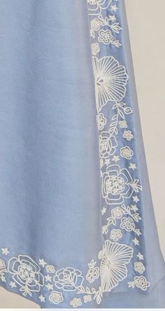 a blue dress with white flowers on it