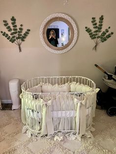 a baby crib in the corner of a room with a mirror on the wall