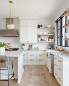 the kitchen is clean and ready for us to use it's white countertops