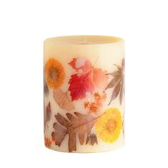 an image of a candle that has leaves on it and flowers painted on the inside