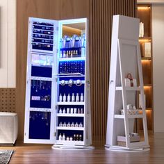 an open refrigerator sitting on top of a wooden floor next to a shelf filled with bottles