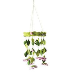 a green and pink flowered mobile hanging from a white ceiling with flowers on it