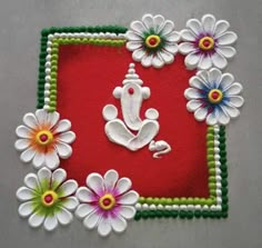 a red and green mat with white flowers on it