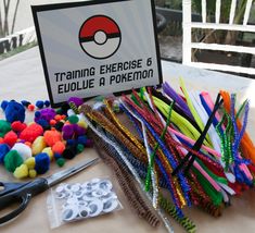 a table topped with lots of different types of beads and crafting supplies on top of it