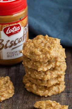 several cookies stacked on top of each other next to a jar of peanut butter