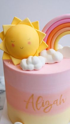 there is a cake that has a sun and rainbow on it