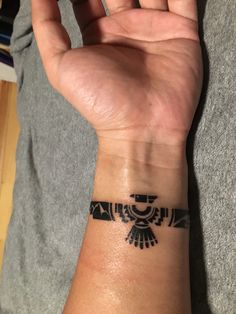 a person's arm with a tattoo on the wrist and an arrow in the middle