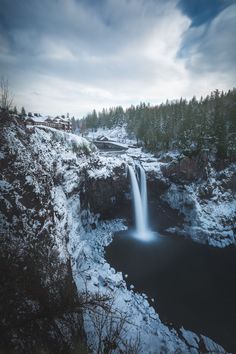 a waterfall in the middle of a snowy landscape