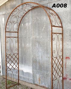 an old metal arch sitting in front of a building