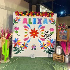 a sign that says alexa and decorated with flowers