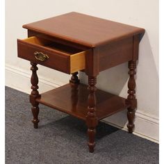 a small wooden table with two drawers