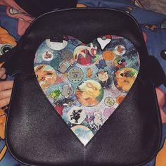 a heart shaped bag with many different pictures on it