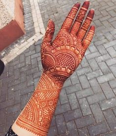 a woman's hand with henna on it