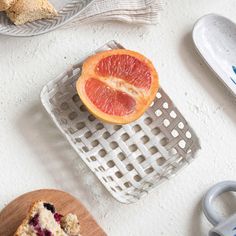 a slice of cake sitting on top of a wooden cutting board next to a plate