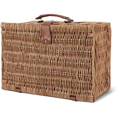 a large wicker basket with leather handles on the front and side, sitting against a white background