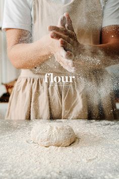 a person is sprinkling flour on top of a doughnut