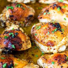 chicken thighs with herbs cooking in a pan