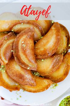 a white plate topped with sliced bananas next to a bowl of pesto