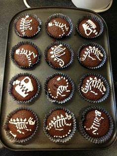 chocolate cupcakes decorated with skeletons and bones