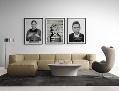 a living room filled with furniture and two pictures on the wall above it's coffee table