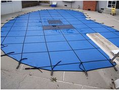 a blue tarp covering a parking lot in front of a building