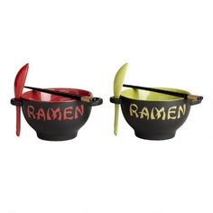 two black and red bowls with wooden spoons in them that say ramen and ramen