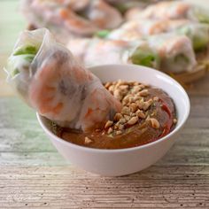 shrimp and vegetable soup in a white bowl with chopsticks sticking out of it