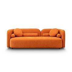 an orange couch sitting on top of a white floor