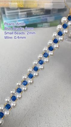 pearls and blue beads are attached to a bracelet