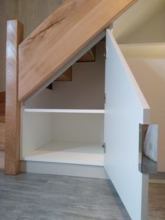 an open closet under the stairs in a house