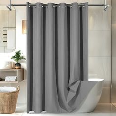 a bathroom with a gray shower curtain next to a toilet