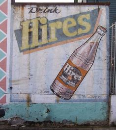 a large sign on the side of a building that says pink tires with an image of a beer bottle