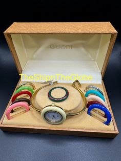 **Authentic Gucci 12 Bezel Watch** Enter the promo code INVENTORY to get a 20% discount on your purchase. **Pre-loved, good condition** - 11/12.2 0999977 - New battery - Currently meets timekeeping standards - Evaluated by a Watch Specialist - Fits up to a 6.25-inch wrist - Clear crystal glass - Comes with 10 acrylic bezels, 2 metallic bezels, and a Gucci box  as seen in the photos Note: The middle part of the watch bracelet is fading, making it look slightly like a two-tone watch band.  Please Modern Gucci Watch Accessories With Subdials, Timeless Gucci Watch With Polished Finish, Gucci G Timeless Watch Gold, Gucci Bezel Watch Vintage, Vintage Gucci Watch Interchangeable, Gucci Watch, Two Tone Watch, Watch Movement, Women Wrist Watch