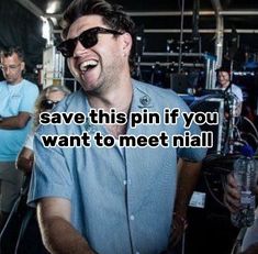 a man laughing while holding a microphone in front of him and people behind him with the words save this pin if you want to meet nail