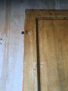 an old wooden door with peeling paint on it