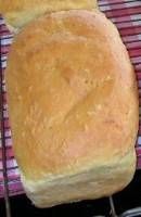 two loafs of bread sitting on top of a grill grate next to each other