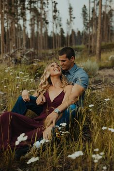 a man and woman sitting in tall grass with the text how to get scenic engagement photos