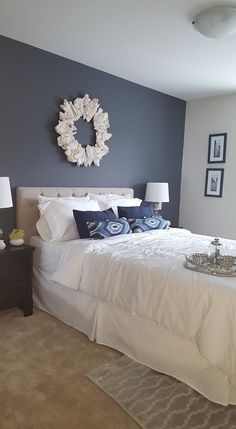 a large white bed sitting in a bedroom next to two lamps