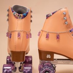 a pair of brown boots with purple wheels and beaded chain around the soles