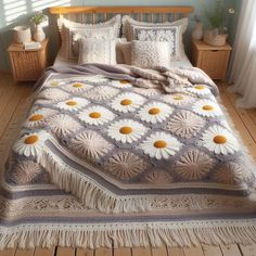 a bed with white and yellow daisies on the comforter next to a window